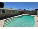 Backyard pool featuring a concrete pool deck, privacy fence, and patio at 4200 Via Vaquero Ave, Las Vegas, NV 89102