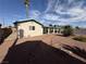 Backyard featuring decorative rock, mature landscaping, and the covered back patio at 4567 S Nellis Blvd, Las Vegas, NV 89121