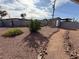 Backyard featuring decorative rock, mature landscaping, a shed, and perimeter fencing at 4567 S Nellis Blvd, Las Vegas, NV 89121