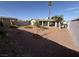 Backyard featuring decorative rock, mature landscaping, and partial view of the house at 4567 S Nellis Blvd, Las Vegas, NV 89121