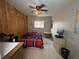 Bedroom with tile floors, wood paneled walls, and natural light at 4567 S Nellis Blvd, Las Vegas, NV 89121