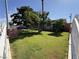 Lush front yard with mature trees and green lawn, enclosed by a decorative fence, adding charm to this well-maintained property at 4567 S Nellis Blvd, Las Vegas, NV 89121