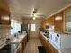 Functional kitchen featuring ample cabinet space, tiled countertops, and essential appliances, ideal for everyday cooking at 4567 S Nellis Blvd, Las Vegas, NV 89121