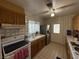 Well-lit kitchen with tiled countertops, functional appliances, a ceiling fan, and ample cabinet space for storage needs at 4567 S Nellis Blvd, Las Vegas, NV 89121