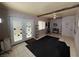 Bright living area with tile floors, exterior access, and cozy furnishings at 4567 S Nellis Blvd, Las Vegas, NV 89121