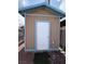 Small outdoor shed with light brown walls and blue trim around the door and roof at 4567 S Nellis Blvd, Las Vegas, NV 89121