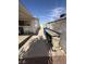 Side yard featuring concrete area, storage containers, and access to the back yard at 4567 S Nellis Blvd, Las Vegas, NV 89121