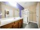 Bathroom featuring a white vanity, glass shower, and closet at 47 Desert Sunflower Cir, Henderson, NV 89002