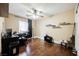 Bedroom with hardwood floors, ceiling fan, and a desk with an office chair at 47 Desert Sunflower Cir, Henderson, NV 89002