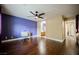 Bedroom with hardwood floors, ceiling fan, a desk, and an ensuite bathroom at 47 Desert Sunflower Cir, Henderson, NV 89002