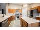 Traditional-style kitchen features wood cabinets, stainless steel appliances, and a tiled floor at 47 Desert Sunflower Cir, Henderson, NV 89002