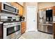 Kitchen with stainless steel appliances and granite countertops, and wooden cabinets at 47 Desert Sunflower Cir, Henderson, NV 89002