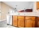 Kitchen with wooden cabinets, tile floors, stainless steel appliances and sink at 47 Desert Sunflower Cir, Henderson, NV 89002