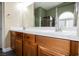 Spacious bathroom with double sinks, vanity, and walk-in shower with glass door at 47 Desert Sunflower Cir, Henderson, NV 89002