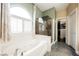 Lovely bathroom with a soaking tub, walk-in shower, and ample natural light at 47 Desert Sunflower Cir, Henderson, NV 89002