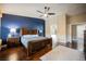 Main bedroom boasting hardwood floors, a large bed, and an ensuite bathroom entrance at 47 Desert Sunflower Cir, Henderson, NV 89002