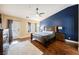 Spacious main bedroom featuring hardwood floors, a ceiling fan, and an accent wall at 47 Desert Sunflower Cir, Henderson, NV 89002