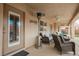 Inviting covered patio featuring wicker seating and a cozy heater for outdoor enjoyment at 47 Desert Sunflower Cir, Henderson, NV 89002