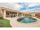 Backyard oasis with a pool, jacuzzi, barbecue area, and covered patio for outdoor living at 47 Desert Sunflower Cir, Henderson, NV 89002