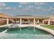 Expansive backyard view, including a sparkling pool, patio with seating, and lush landscaping at 47 Desert Sunflower Cir, Henderson, NV 89002