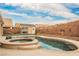 Beautiful pool with a jacuzzi, surrounded by a brick wall with an additional shed for storage at 47 Desert Sunflower Cir, Henderson, NV 89002