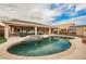 Enjoy a backyard retreat with a large pool, a jacuzzi, and a covered patio with solar panels at 47 Desert Sunflower Cir, Henderson, NV 89002