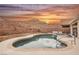 Enjoy this backyard pool and spa framed by mountains and a breathtaking sunset sky at 47 Desert Sunflower Cir, Henderson, NV 89002