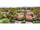 Aerial view of neighborhood featuring lush landscaping, tile roofs, and mature trees at 5123 Southern Hills Ln, Las Vegas, NV 89113