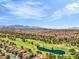 Extensive aerial view captures a golf course with a tranquil lake, surrounded by residential homes and desert landscaping at 5123 Southern Hills Ln, Las Vegas, NV 89113