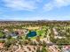 Panoramic aerial view showcases a community with a lake and golf course, set against a backdrop of the city skyline at 5123 Southern Hills Ln, Las Vegas, NV 89113