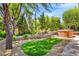 Lush backyard with a relaxing hot tub and artificial turf at 5123 Southern Hills Ln, Las Vegas, NV 89113
