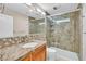 Bathroom showcasing granite countertop, single sink vanity, and a glass enclosed shower with built-in shelving at 5123 Southern Hills Ln, Las Vegas, NV 89113