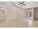 Well-lit bedroom features neutral walls, tile flooring, and glass doors with view to the backyard at 5123 Southern Hills Ln, Las Vegas, NV 89113