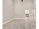 Bright bedroom showing tile flooring, neutral walls, and doorway that leads to ensuite bathroom at 5123 Southern Hills Ln, Las Vegas, NV 89113