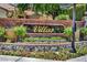 The Villas entrance with brick walls, flower beds, and decorative street lamp at 5123 Southern Hills Ln, Las Vegas, NV 89113