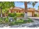A lovely home featuring mature trees, lush lawn, and a charming tile roof at 5123 Southern Hills Ln, Las Vegas, NV 89113