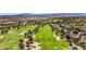 Scenic aerial view featuring a lush green golf course with sand traps and residential homes in a suburban community at 5123 Southern Hills Ln, Las Vegas, NV 89113