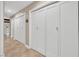 Hallway with multiple white closet doors offering ample storage space throughout the home at 5123 Southern Hills Ln, Las Vegas, NV 89113
