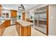 Spacious kitchen boasts granite island, stainless steel refrigerator, and ample cabinet space at 5123 Southern Hills Ln, Las Vegas, NV 89113