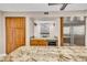 Elegant kitchen featuring custom wood cabinets, granite counters, and stainless steel refrigerator at 5123 Southern Hills Ln, Las Vegas, NV 89113