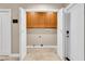 Functional laundry room featuring cabinetry above appliances, ample space, and convenient access to other areas at 5123 Southern Hills Ln, Las Vegas, NV 89113