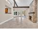 Open living room featuring vaulted ceiling, stone fireplace, and access to the patio at 5123 Southern Hills Ln, Las Vegas, NV 89113