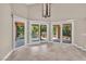 Bright living room with multiple patio doors leading to an outdoor living area at 5123 Southern Hills Ln, Las Vegas, NV 89113