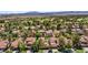 Wide aerial view of a residential area with manicured front lawns, mature trees, and classic red tile roofs at 5123 Southern Hills Ln, Las Vegas, NV 89113