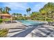 Community pool with lounge chairs, palm trees, shade canopies and sunny blue skies at 5123 Southern Hills Ln, Las Vegas, NV 89113