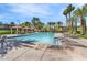 Community pool with seating, sun loungers, palm trees and clear blue sky at 5123 Southern Hills Ln, Las Vegas, NV 89113