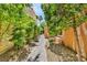 A tranquil side yard featuring a stone pathway and verdant trees at 5123 Southern Hills Ln, Las Vegas, NV 89113