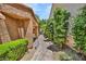 An inviting side yard featuring a stone pathway and mature trees at 5123 Southern Hills Ln, Las Vegas, NV 89113