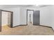 Spacious bedroom with neutral carpeting, gray trim, and multiple doorways, offering a serene atmosphere at 538 Kristin Ln, Henderson, NV 89011