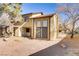 Two-story home with yellow siding and large windows, surrounded by natural landscaping at 538 Kristin Ln, Henderson, NV 89011